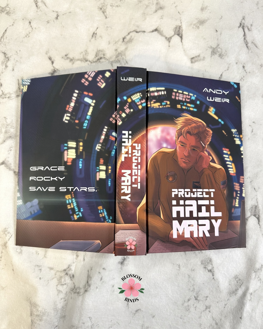 Flat lay display of "Project Hail Mary" full cover on marbled surface