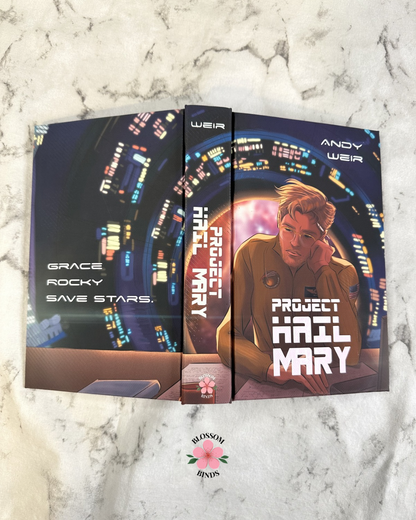 Flat lay display of "Project Hail Mary" full cover on marbled surface