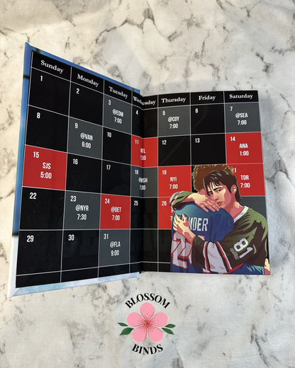 Calendar with a sports theme on a marble surface, featuring the brand 'Blossom Binds'.
